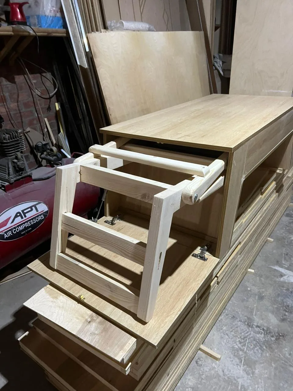 The chair frame sliding out of the built table