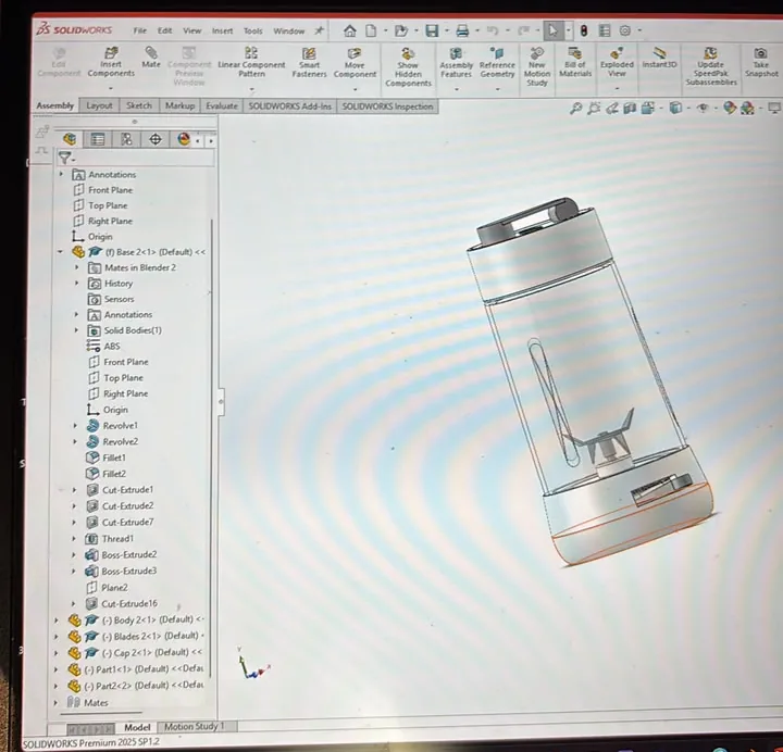 Laptop screen showing the blender assembly in SolidWorks