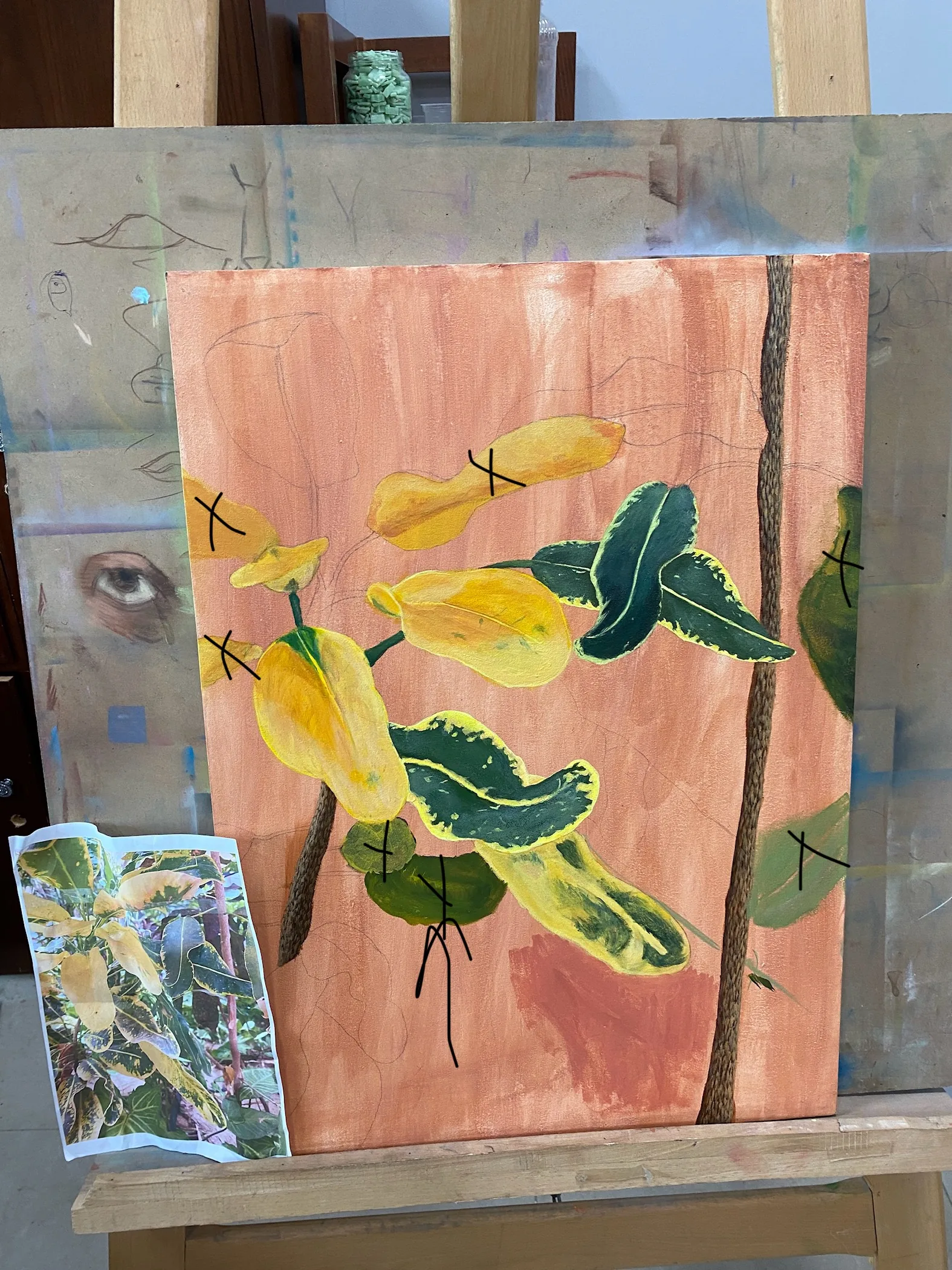 Painting in progress on an easel with the reference photo beside it