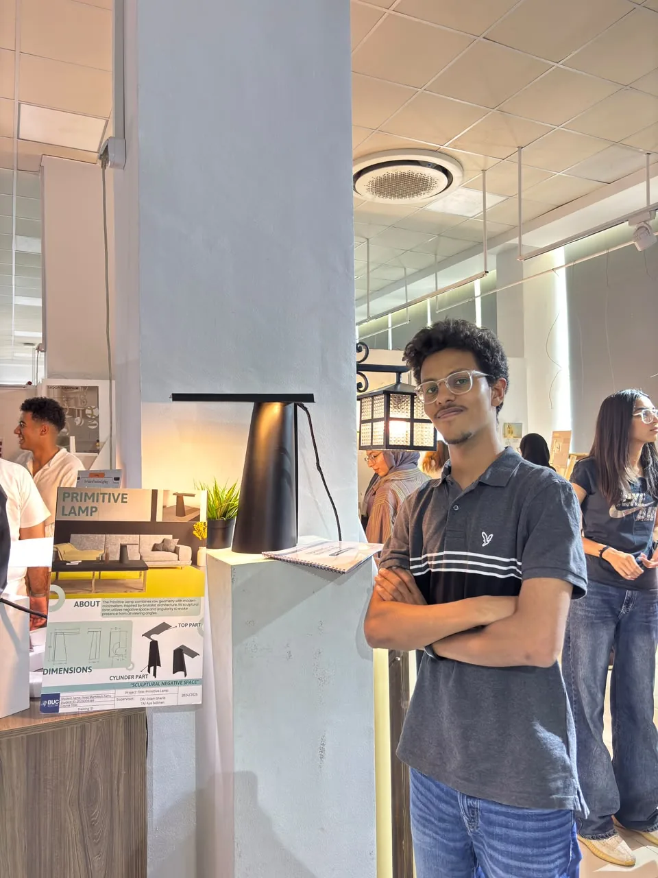 Feras standing next to his lamp at the jury exhibition