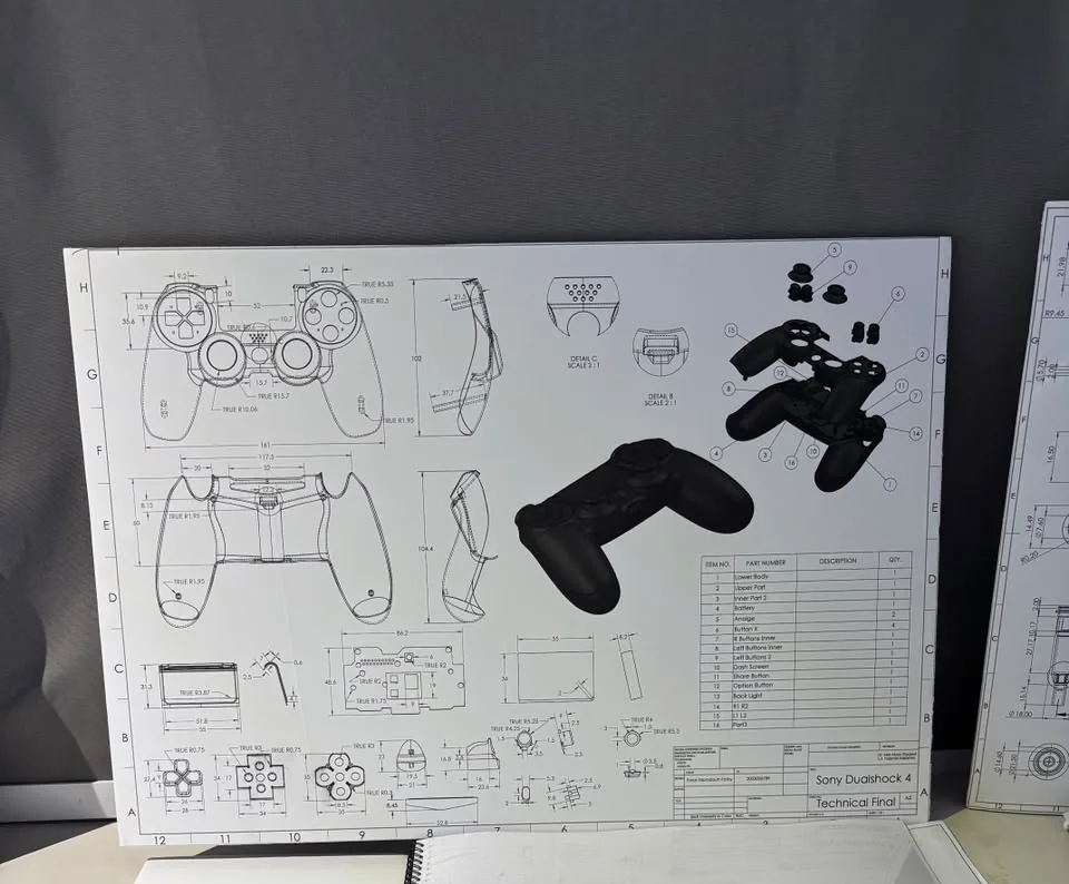 Printed drawing board of the controller with the real controller on the table